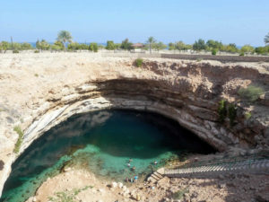 Bimmah sinkhole and people swimming in it