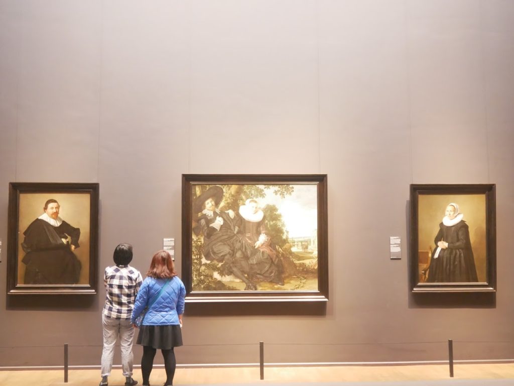 People watching paintings inside of Rijksmuseum