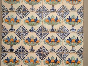 Historical white tiles with blue and orange fruit images on them