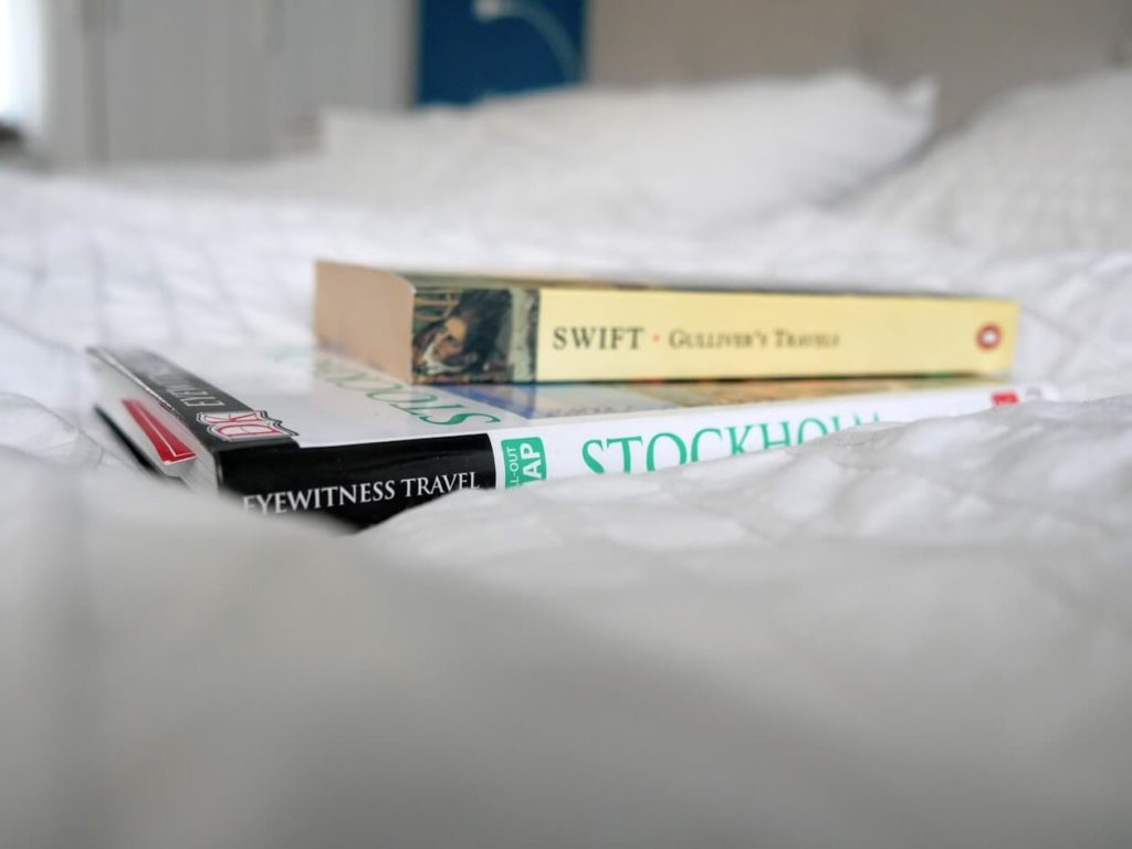 Travel books on a bed