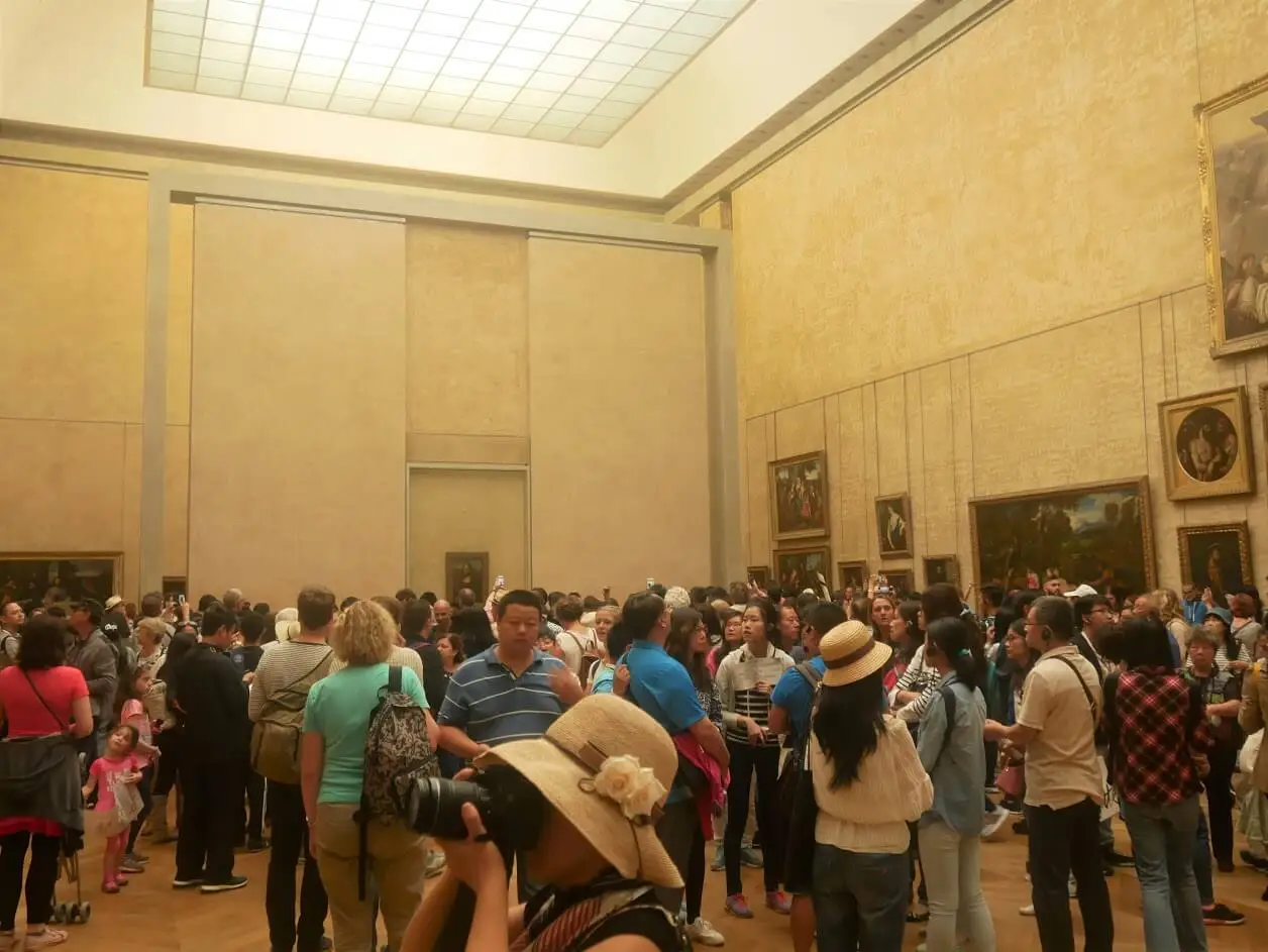 Crowds at the Mona Lisa room at Louvre museum in Paris