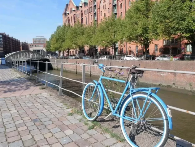 Bicycle tied to a fence on Hamburg's canal