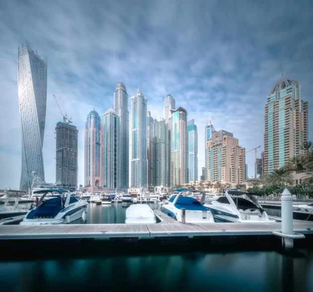 Panoramic day view of sea bay with yachts at sunset in Dubai Marina, UAE