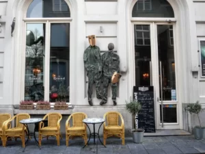 Statues with masks on street in Maastricht