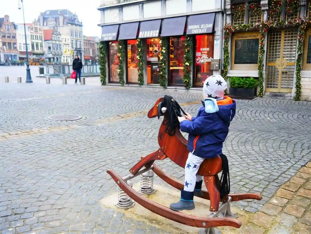 Karlo on horse toy on main sqaure in Mechelen